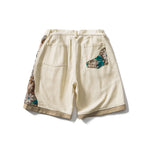 Load image into Gallery viewer, PANELED EMBROIDERED KNEE SHORTS
